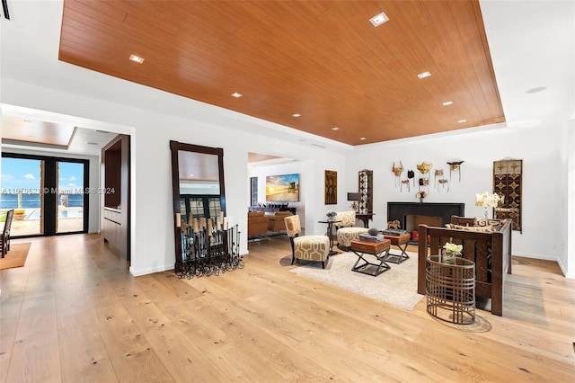 living room with french doors, light hardwood / wood-style floors, and wood ceiling