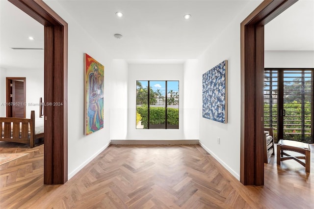 hallway featuring light parquet flooring