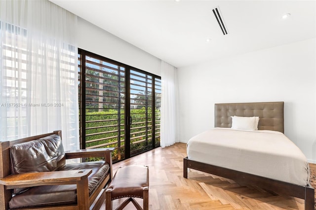 bedroom with light parquet flooring