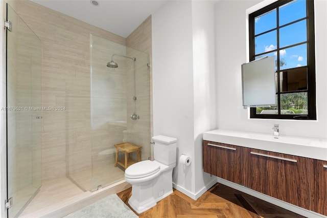 bathroom with a healthy amount of sunlight, toilet, parquet flooring, and walk in shower