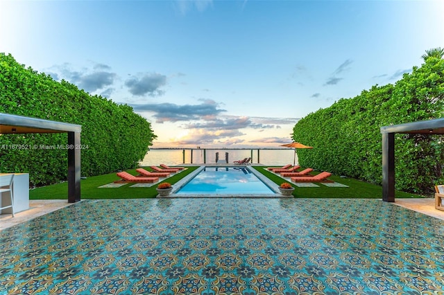 pool at dusk with a lawn