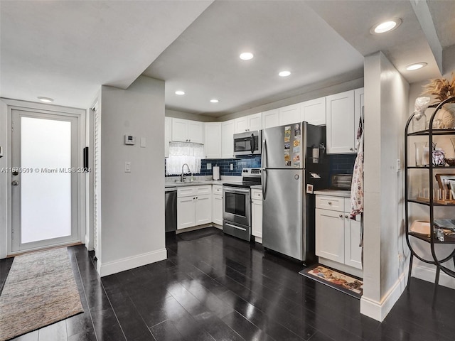 kitchen featuring sink, white cabinetry, stainless steel appliances, and dark hardwood / wood-style floors