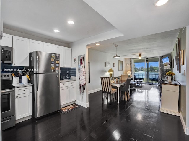 kitchen with appliances with stainless steel finishes, ceiling fan, white cabinetry, and tasteful backsplash