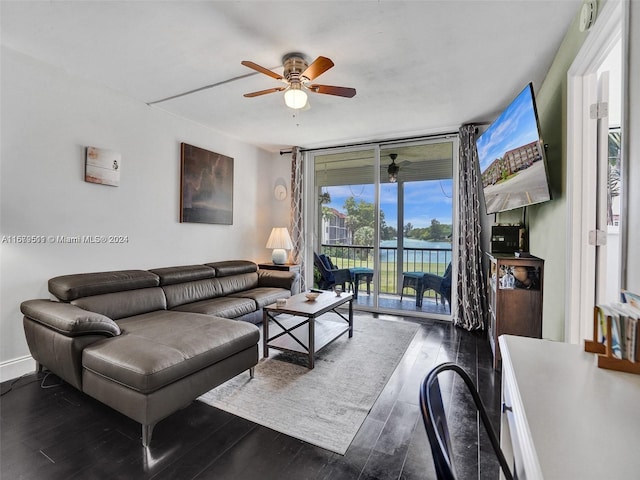 living room featuring ceiling fan, expansive windows, and dark hardwood / wood-style flooring