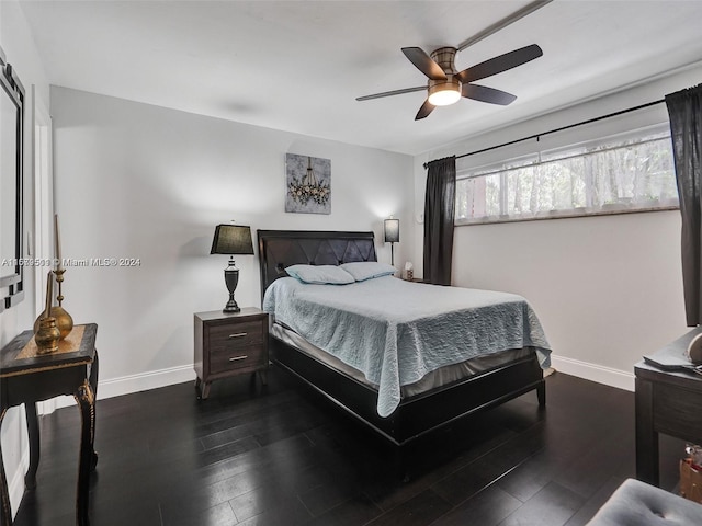 bedroom with dark hardwood / wood-style floors and ceiling fan