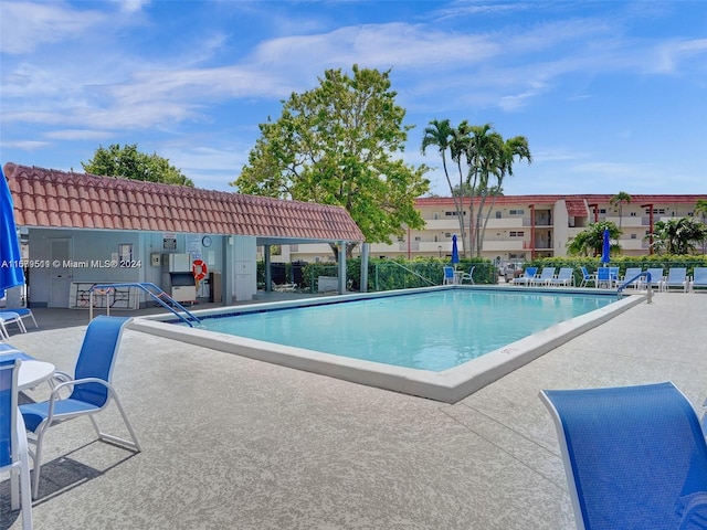 view of swimming pool with a patio