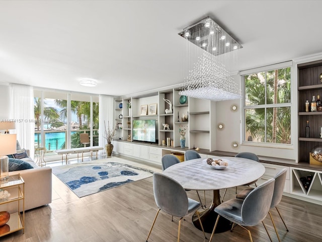 dining space with hardwood / wood-style flooring and floor to ceiling windows