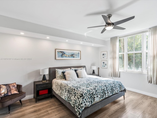 bedroom with ceiling fan, ornamental molding, and hardwood / wood-style floors