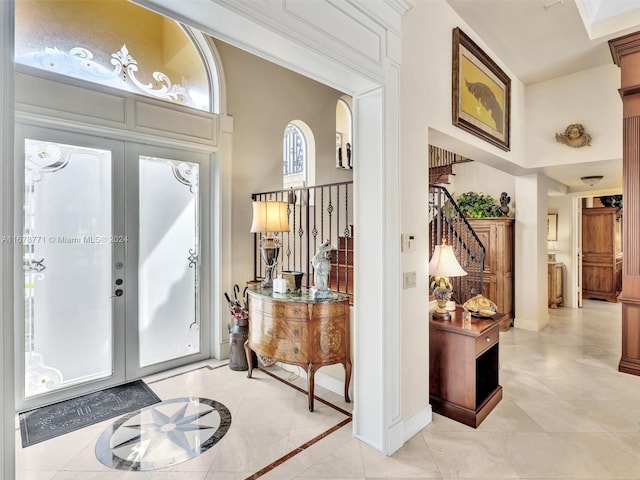 449 Isle Of Palms Dr, Fort Lauderdale, FL 33301 - entryway featuring french doors, stairway, baseboards, light tile patterned floors, and a high ceiling