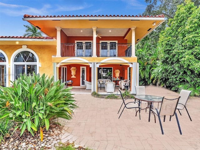 449 Isle Of Palms Dr, Fort Lauderdale, FL 33301 - back of property with outdoor dining space, stucco siding, a balcony, a ceiling fan, and a patio