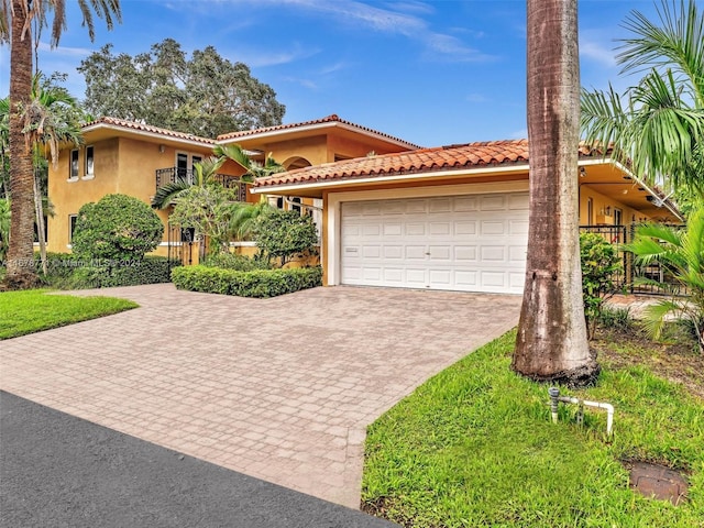 449 Isle Of Palms Dr, Fort Lauderdale, FL 33301 - mediterranean / spanish-style home featuring a tiled roof, stucco siding, decorative driveway, and a garage