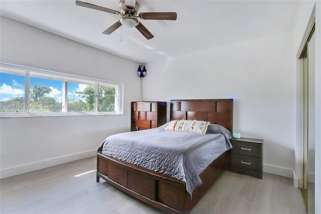 bedroom with light hardwood / wood-style flooring and ceiling fan