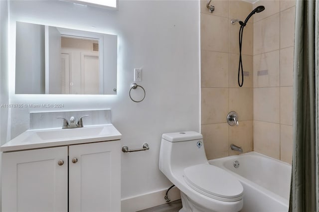 full bathroom with toilet, tiled shower / bath, and vanity