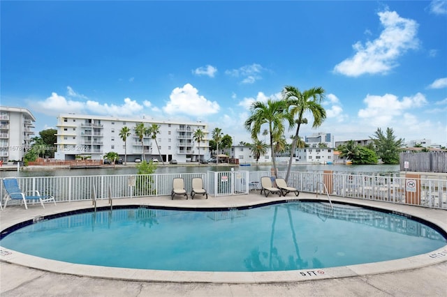 view of pool featuring a patio and a water view