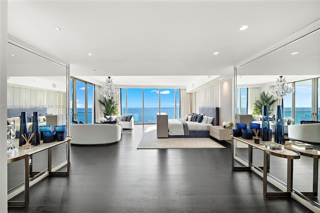 living room with expansive windows, wood finished floors, recessed lighting, and an inviting chandelier