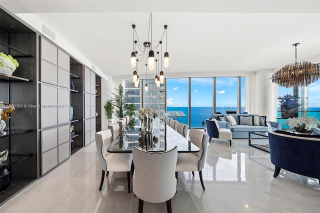 dining area with a wealth of natural light, a water view, floor to ceiling windows, and a notable chandelier