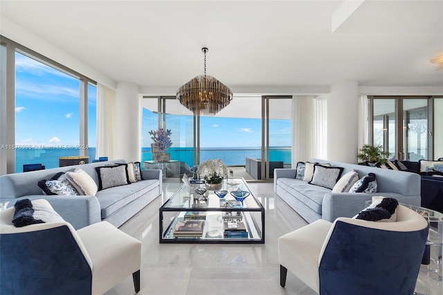 sunroom with an inviting chandelier, plenty of natural light, and a water view