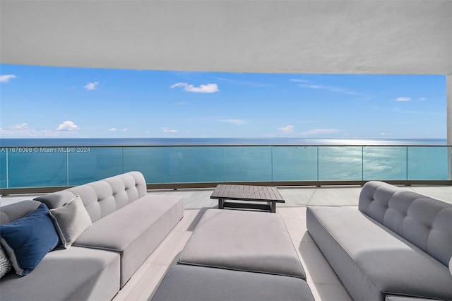 balcony featuring outdoor lounge area and a water view