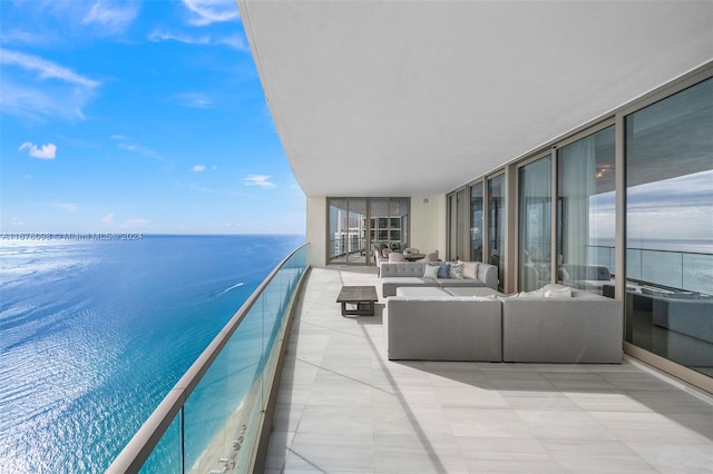 balcony with outdoor lounge area and a water view