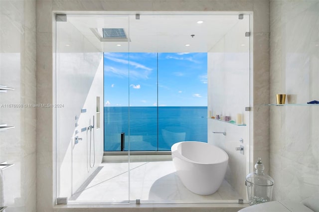 bathroom with independent shower and bath and a water view