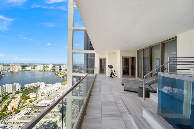 balcony featuring a water view and a view of city