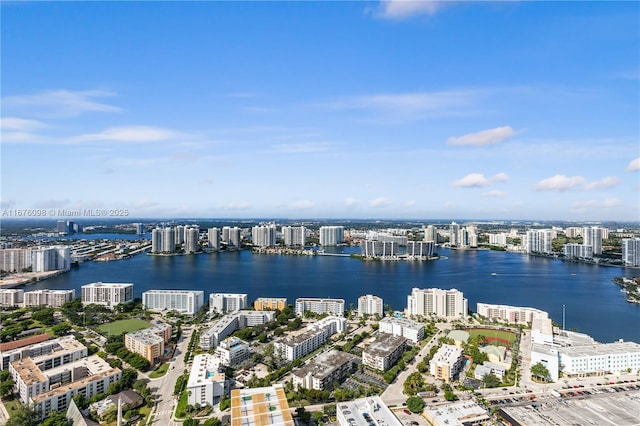 drone / aerial view featuring a view of city and a water view