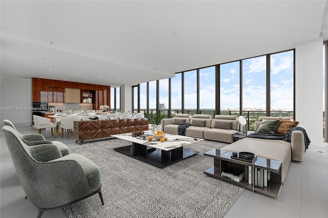 living room featuring plenty of natural light, floor to ceiling windows, and light tile patterned floors