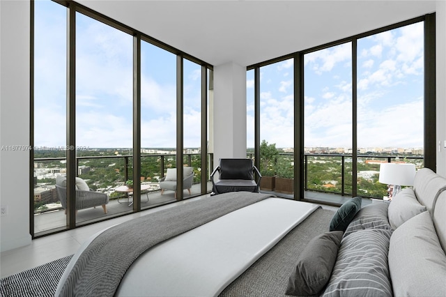 tiled bedroom featuring a wall of windows and multiple windows