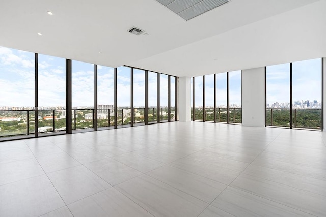 unfurnished room featuring floor to ceiling windows and light tile patterned floors