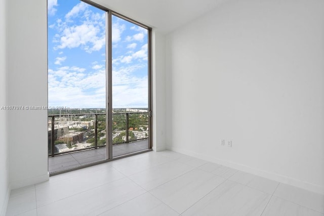 tiled empty room with floor to ceiling windows