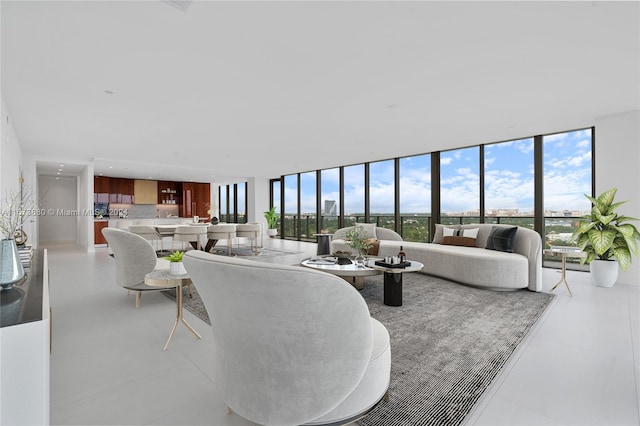 tiled living room featuring a wall of windows