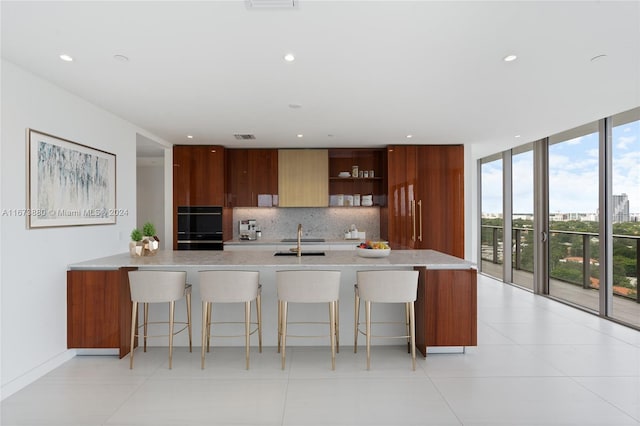 kitchen with plenty of natural light, sink, backsplash, and double oven