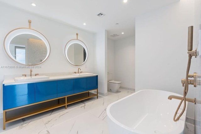 bathroom with a bathing tub, vanity, and toilet