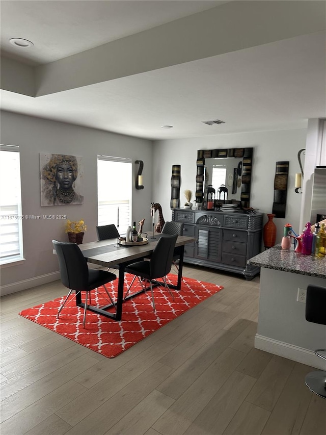 dining area with hardwood / wood-style floors