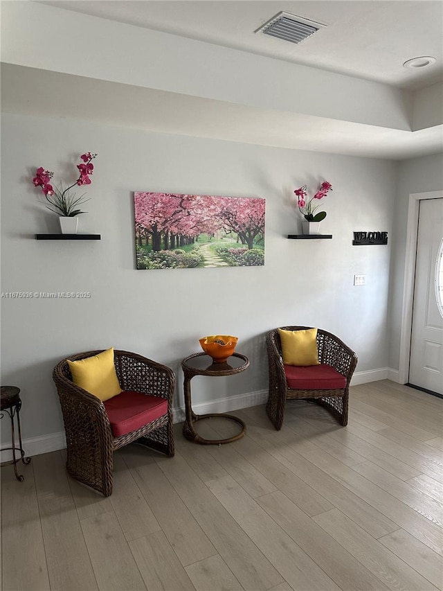 living area with light hardwood / wood-style flooring