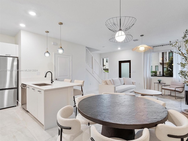 tiled dining space featuring sink