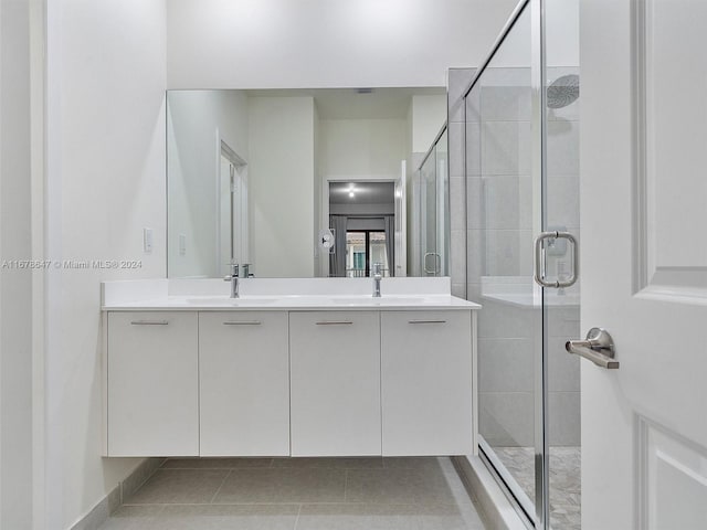 bathroom with vanity, tile patterned flooring, and walk in shower