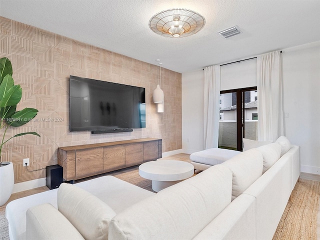 living room with a textured ceiling and hardwood / wood-style flooring