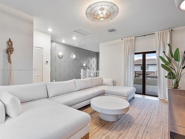 living room with a textured ceiling and wood-type flooring