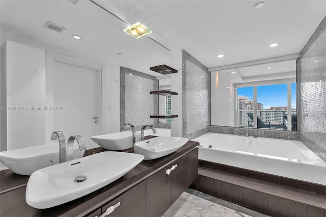 bathroom featuring vanity and a tub