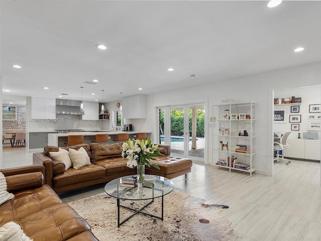 living room featuring sink and french doors