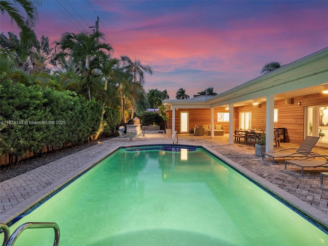 outdoor pool featuring a patio area and outdoor lounge area