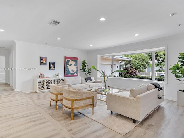 living room featuring recessed lighting, visible vents, light wood-style flooring, and ornamental molding