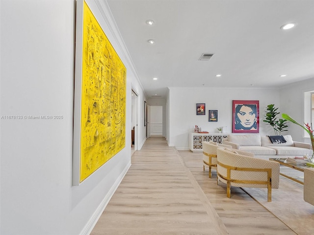 hall with baseboards, visible vents, light wood-style flooring, recessed lighting, and crown molding