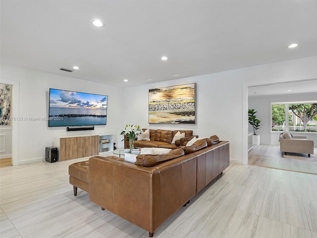 living room with recessed lighting, visible vents, and baseboards