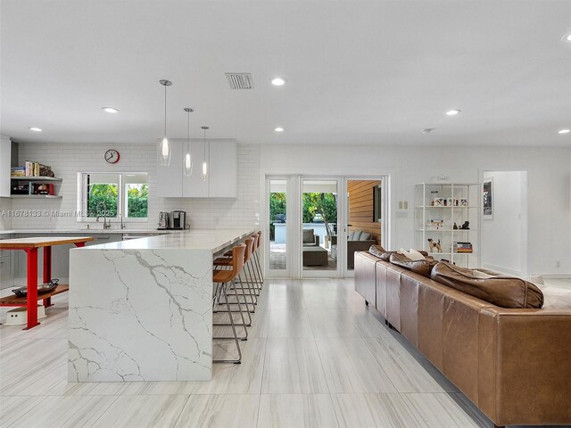 dining area featuring light hardwood / wood-style floors, ornamental molding, and a chandelier