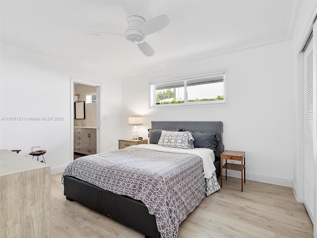 bedroom featuring a closet, baseboards, light wood-style floors, and ornamental molding