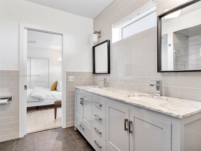 bathroom with vanity, tile walls, and tile patterned flooring