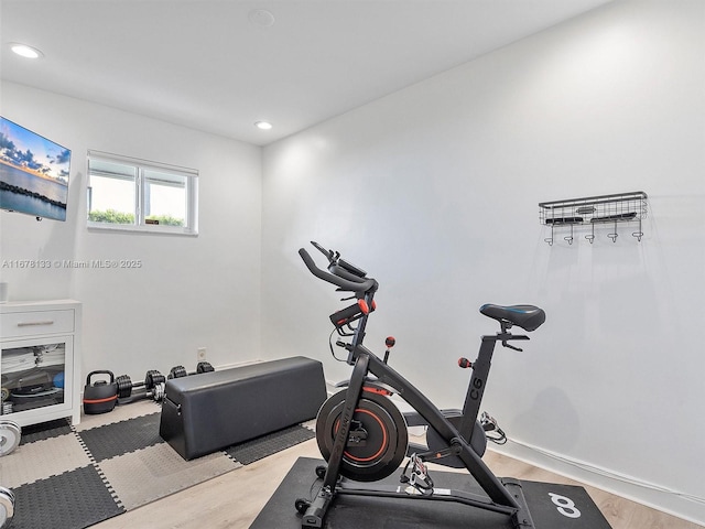 exercise room with recessed lighting, baseboards, and wood finished floors