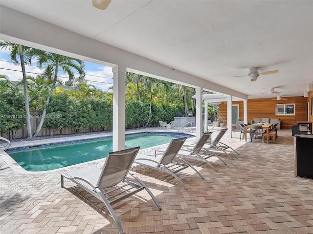 view of swimming pool featuring a patio area and ceiling fan